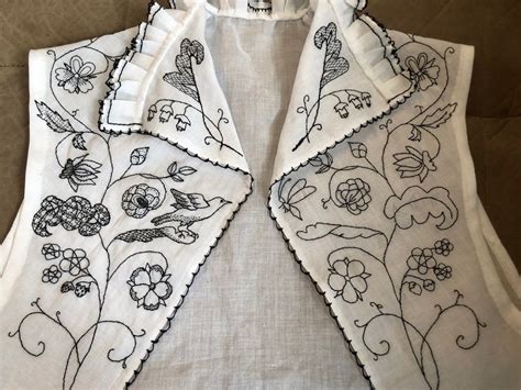 An Embroidered Vest With Flowers And Birds On It