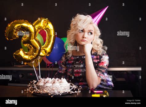 Anniversary Birthday Young Beautiful Blonde Sitting In Front Of A Birthday Cake And Sad