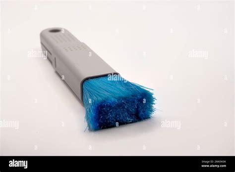 Close Up Of A Plastic Extending Pc And It Dush Brush With Blue Nylon