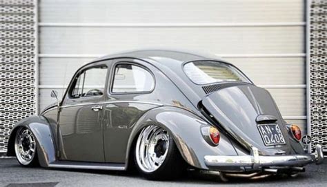 Gray Vw Bug Parked In Front Of Garage Door