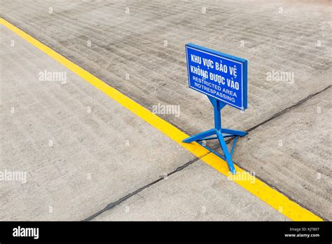 Blue Sign For Restricted Area No Trespassing In Vietnamese And