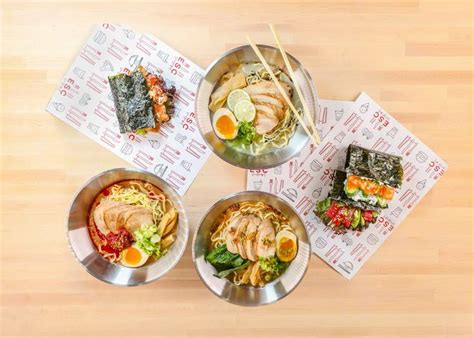 Three Silver Bowls Filled With Food Sitting On Top Of A Wooden Table