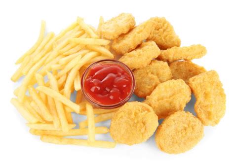 Fried Chicken Nuggets With French Fries And Sauce Isolated On White