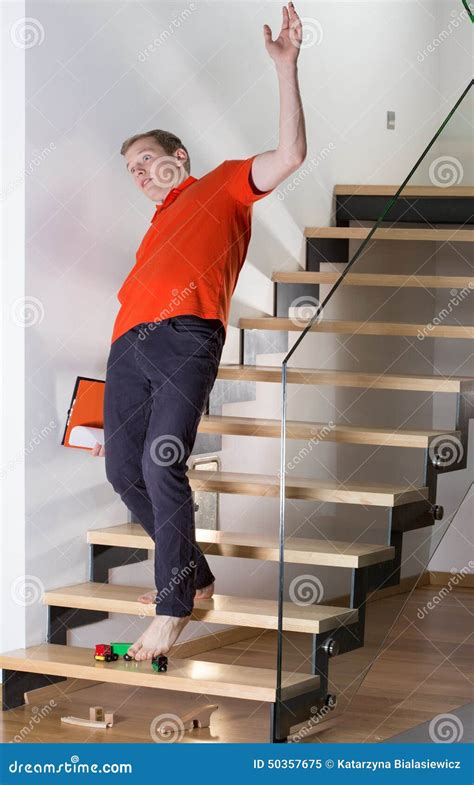 Man Stumbling Over Child's Toy Stock Photo - Image: 50357675