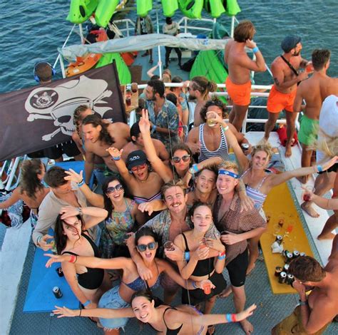 A Group Of People Standing On Top Of A Boat