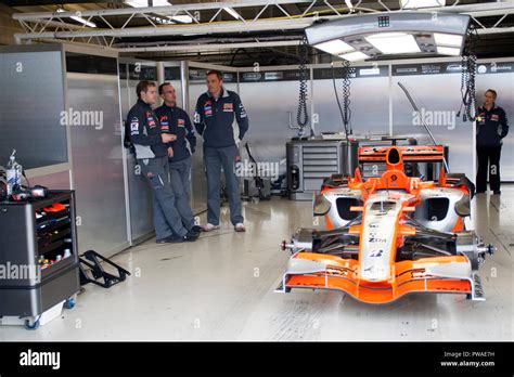 F1 Mechanics At Work On A F1 Race Car In The Pit Lane Workshop