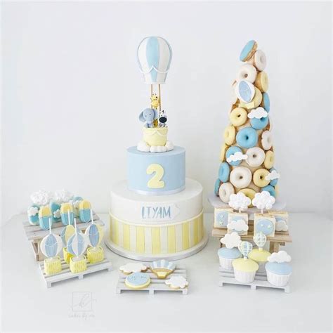 A Blue And Yellow Birthday Cake Surrounded By Cupcakes Cookies And