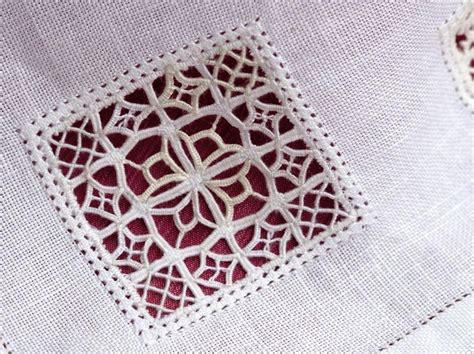 A Close Up Of A Piece Of Cloth With Crochet Work On The Edges