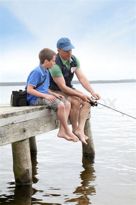 Father and son fishing in lake | Stock image | Colourbox