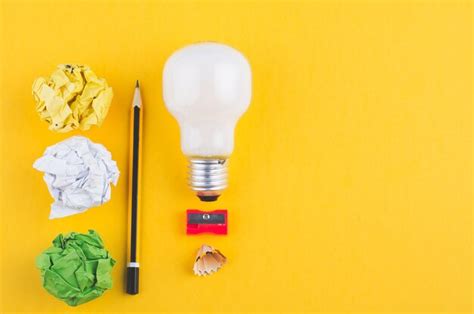 Premium Photo High Angle View Of Light Bulb And Pencils On Yellow