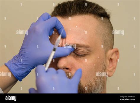 Esthetician Making Botulinum Toxin Injections To Male Patient Beauty