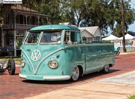 An Old Vw Bus Is Parked On The Street