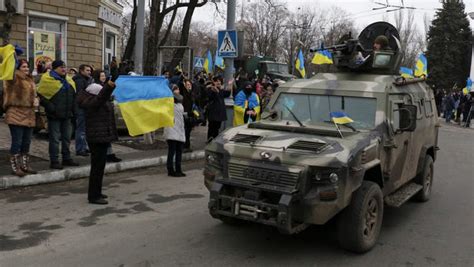 Residents Wave Ukrainian Flags Wednesday As They Cheer Ukrainian Troops