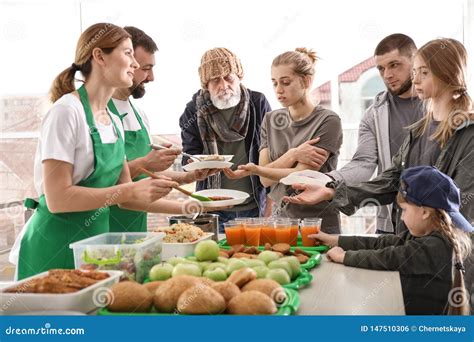 Volunteers Giving Food To Poor People Stock Photo Image Of Child