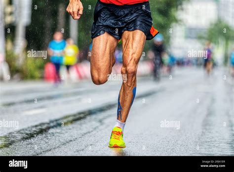 Close Up Muscular Legs Male Runner Running Marathon City Race Athlete