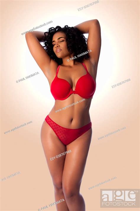 Beautiful Happy Plus Size Sexy Woman With Curly Hair In Red Lingerie