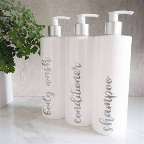 Three Personalized Hand Soap Bottles Sitting On A Counter Next To A