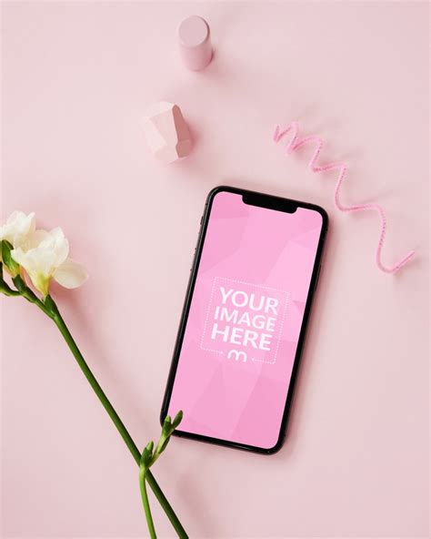 iPhone and Flower on Pink Background Mockup - Mediamodifier