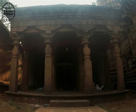 An Old Stone Building With Pillars And Arches