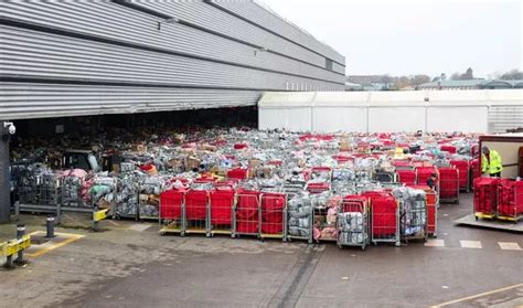 Piles of post at Royal Mail Bristol centre pictured 17 hours apart ...