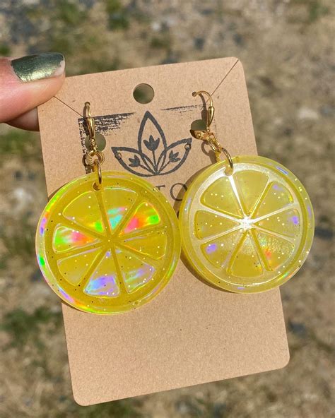 Bright Translucent Yellow Holographic Citrus Slice Dangle Earrings Hanging On Gold Spring Clasp