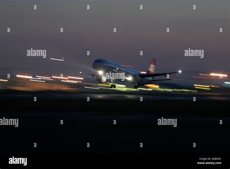 Airliner taking off at night Stock Photo - Alamy