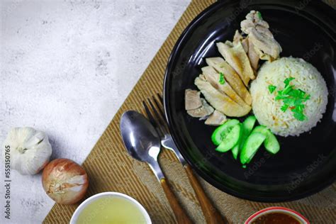 Hainanese chicken rice with soup or steamed chicken and sauces. Stock Photo | Adobe Stock