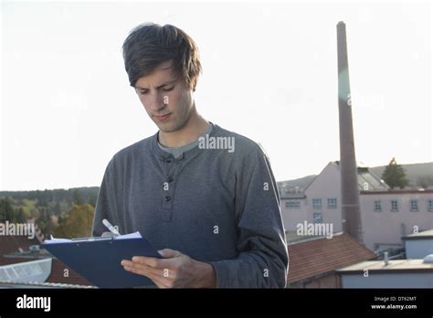 Man Writing On Clipboard Outside Brewery Stock Photo Alamy