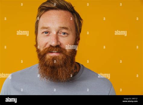 Bearded Happy Man Posing At Camera While Standing Isolated Over Yellow