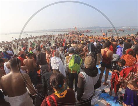 Image Of Crowd Of Indian Devotees Taking Holy Bath In Triveni Sangam