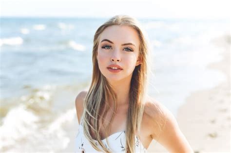 Premium Photo Happy Blonde Woman In Free Happiness Bliss On Ocean Beach Standing Straight And