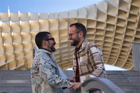 Real Marriage Of Gay Couple Holding Hands With A Railing Of A Stairs In The Middle Of The Two
