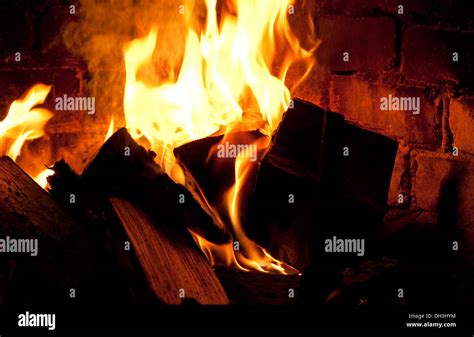 log fire in hearth burning wood logs Stock Photo - Alamy