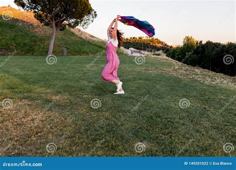 Woman Holding The Gay Rainbow Flag At Sunset Happiness Freedom And