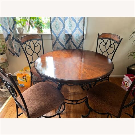 Ashley Round Dining Room Table with Four Chairs - AptDeco