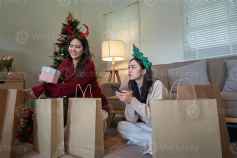 Lesbian Pair Engaging In Holiday Gift Sorting A Festive Exercise Of Joyful Planning