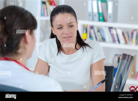Brunette Female Doctor Talking To Patient In The Hospital Stock Photo Alamy