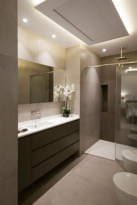 A Bathroom With A Sink Toilet And Shower Stall In The Middle Of It Is