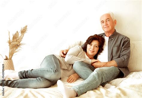 Mature 60 Year Old Couple Hugging While Laying On The Bed In The Bedroom Stock Photo Adobe Stock