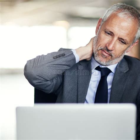 He Needs Some Stress Management A Mature Businessman Looking Stressed While Working In His