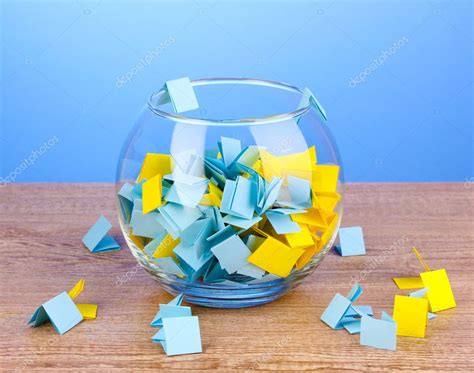 pieces  paper  lottery  vase  wooden table  blue background