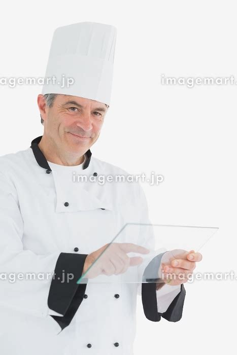 Portrait Of Happy Male Chef Using Glass Tablet Against White Background