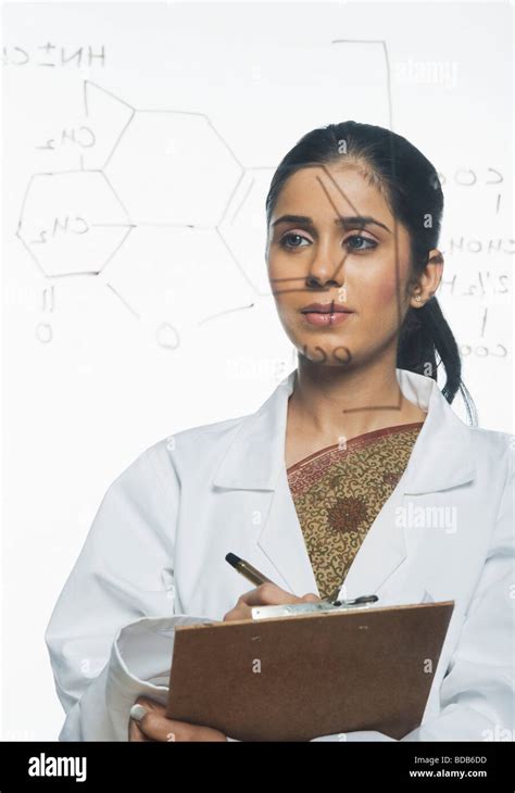 Scientist Writing Chemical Formula On A Clipboard Stock Photo Alamy