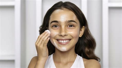 Cute Beautiful Natural Brunette Girl Cleaning Face With Cotton Sponge Smiling Looking At Camera