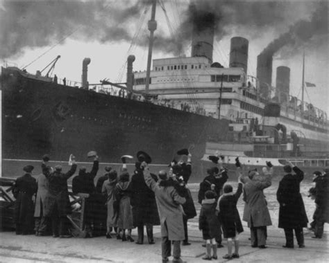 Aquitania is a mammoth next to the people waving to the passengers ...