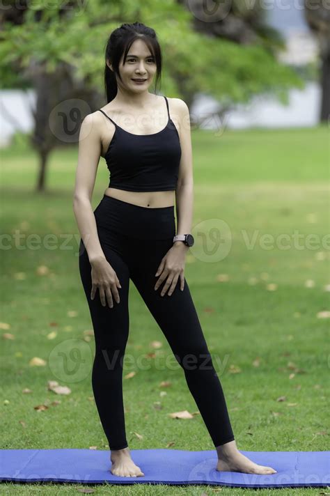 Portrait Of Young Asian Woman Play Yoga In The Public Park 10979979