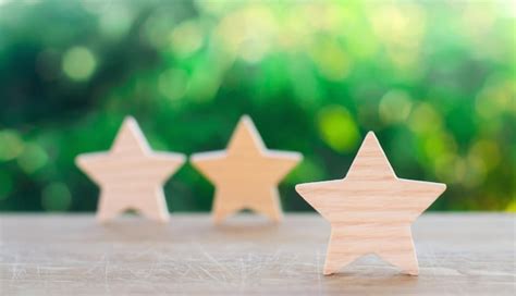 Premium Photo | Three wooden stars on a green bokeh background the ...