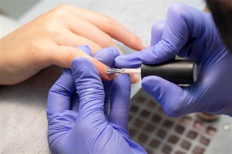 Premium Photo The Manicurist Makes Nude Gel Polish Nails For The Client The Process Of