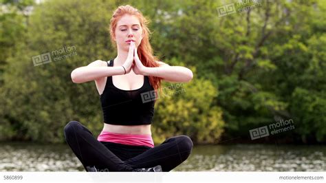 Calm Redhead Doing Yoga By A Lake Stock Video Footage 5860899