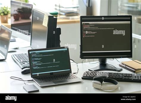 Horizontal image of computer monitor and laptop with software on the ...